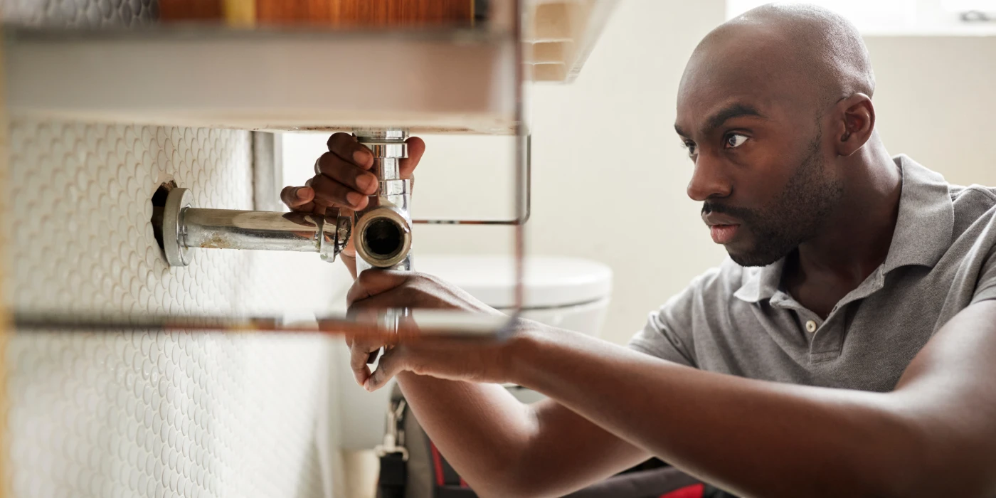 a male plumber fixing a pipe connection from The Leander Plumber - Company in Leander, TX - Plumber near me a male plumber fixing a pipe connection from The Leander Plumber - Company in Leander, TX - Plumber near me