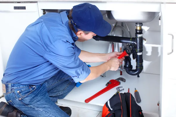 a male plumber fixing a toilet from The Leander Plumber - Company in Leander, TX - Plumber near me a male plumber fixing a toilet from The Leander Plumber - Company in Leander, TX - Plumber near me
